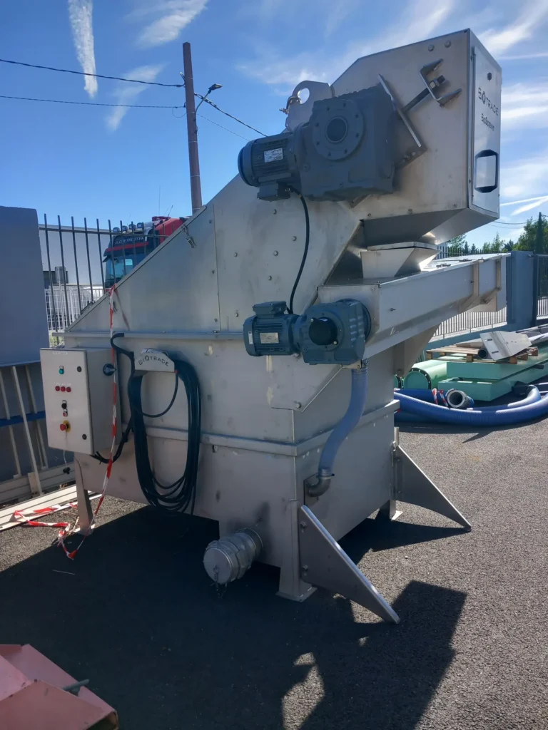 Vue de face du dégrilleur matières de vidange BioScreen Biotrade avec double motoréducteur, armoire de commande et caisson inox