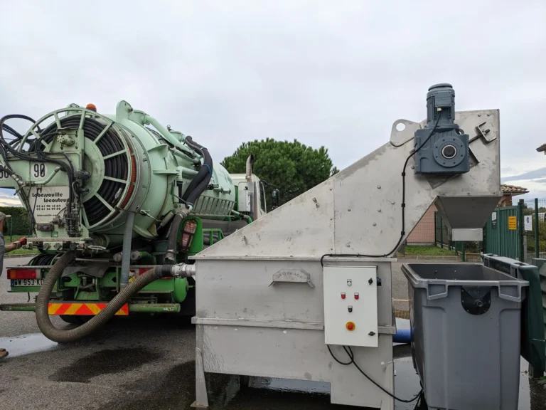 Dégrilleur matières de vidange Biotrade en fonctionnement avec camion hydrocureur connecté et bacs de collecte des refus
